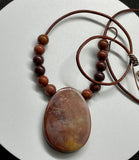 This Necklace Features a Red Jasper Focal with Red Jasper Beads on Leather with a Copper Clasp. 