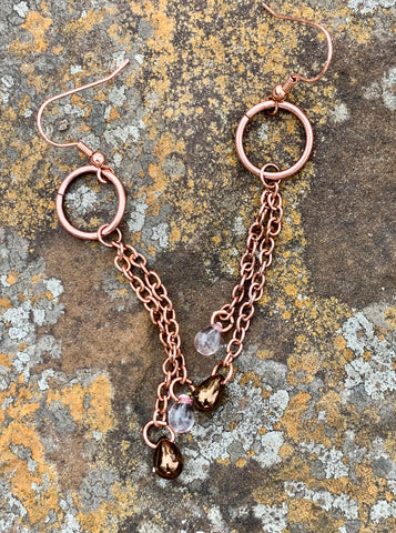 Czech glass teardrops hang from copper chain suspended from a copper circle in these fun and flirty earrings