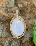 This Beautiful Iridescent Moonstone Pendant Wrapped in Sterling Silver is a stunning piece of jewelry that combines the enchanting qualities of moonstone with the elegance of sterling silver. Its iridescent shimmer and refined silver setting make it a timeless and sophisticated accessory, perfect for any jewelry collection.