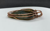 Brilliant Labradorite Pendant wrapped in Copper. It has flashes of blue, green, yellow and purple! 