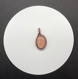 Shimmering, Carved Peach Moonstone Pendant in Wire Wrapped Copper with Copper Leaves Accent.