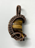 Lovely Striped Golden Tiger Eye Moon Pendant wrapped in handwoven Copper and then given a patina to match the colors in the stone.