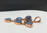 This Copper Pendant featuring 6 Blue Dumortierite Cabochons and 3 Faceted Rainbow Moonstones is a striking and intricate piece of jewelry. The pendant showcases a sophisticated blend of blue dumortierite and rainbow moonstone, all elegantly set in copper. This pendant embodies a harmonious combination of deep, rich colors and vibrant, iridescent highlights.