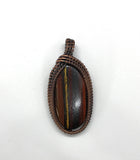 Tiger Iron Pendant wrapped in Copper
