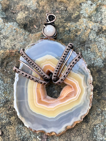 Beautiful One of a Kind Polished Agate Slice Pendant with a druzy center and hues of peach and yellow, in wire wrapped Copper with a Sunstone Accent.