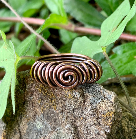 A simple yet stunning design, this ring showcases polished copper swirls that shine beautifully in the light. Handcrafted with care, its minimalist style makes it a versatile accessory for any occasion.