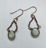 Beautiful blue with a touch of green Czech Glass drops, surrounded by hammered copper. These are dangling from copper chain and hang on handmade ear wires.