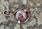 Hand formed Copper Pin with a dark (almost purple) Sunstone focal and smaller Sunstones around it.