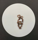 Shimmering Star Sunstone pendant in heavy gauge copper and handwoven and coiled copper weaves.