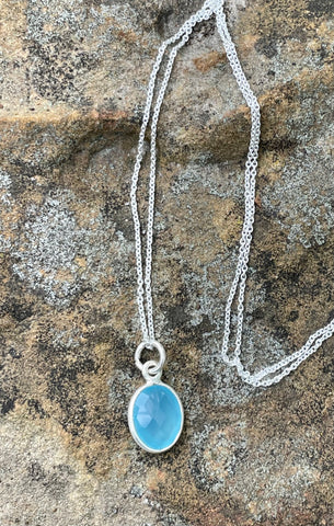 This elegant dainty necklace features a mesmerizing blue chalcedony gemstone, delicately set in sterling silver. The soft, tranquil hues of the chalcedony evoke a sense of calm and serenity, making it the perfect accessory for everyday wear or special occasions. Its minimalist design highlights the stone’s natural beauty, ensuring it complements any outfit effortlessly.